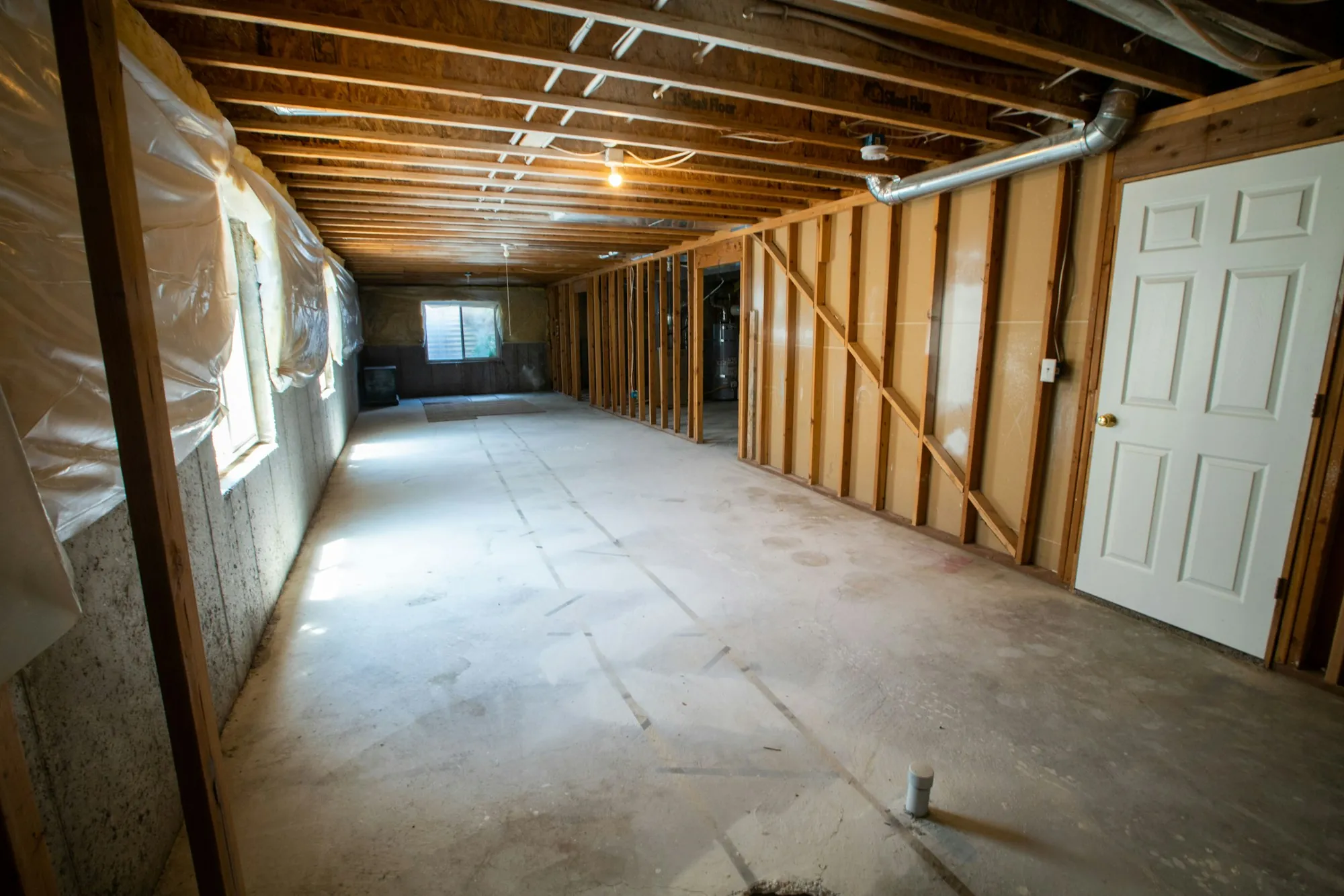 Unfinished basement with framed walls ready to finish